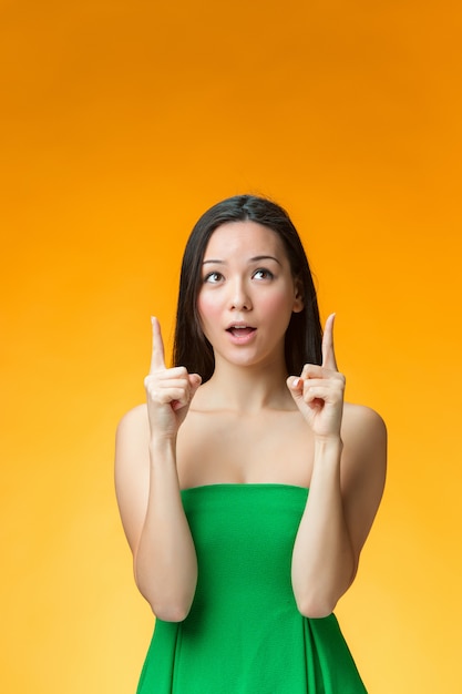 The happy woman on orange wall