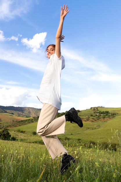 Free photo happy woman outdoors jumping up