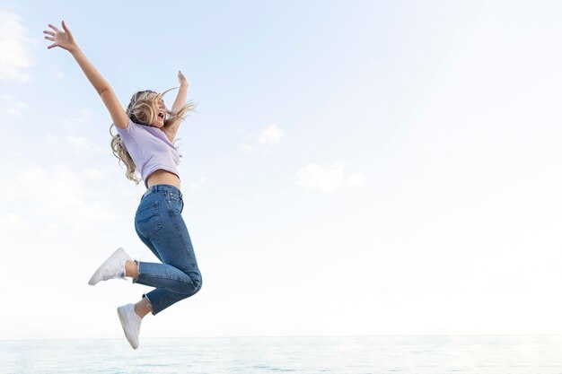 Happy woman outdoors jumping up