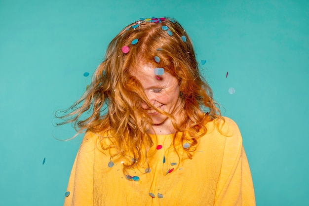 Free photo happy woman partying with confetti in her hair