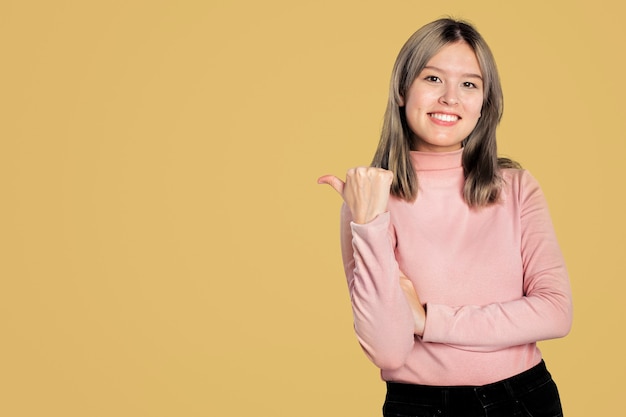 Free photo happy woman in a pink turtleneck