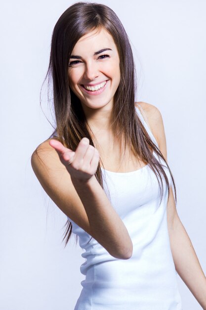 Happy woman pointing at camera