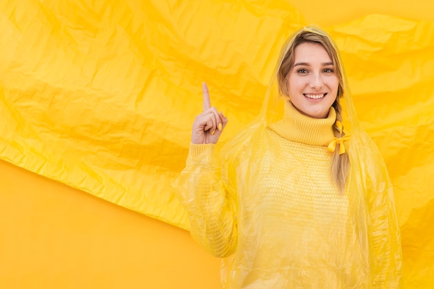 Free photo happy woman pointing up