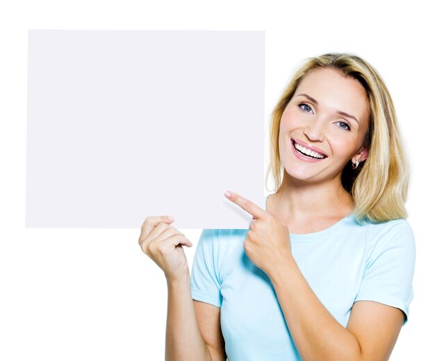 Happy woman points on the blank banner - isolated on white