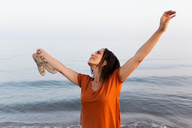 Happy woman posing on the beach