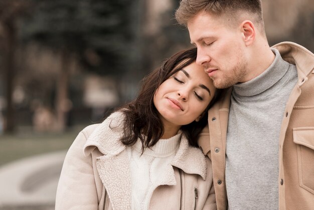 Happy woman posing next to man