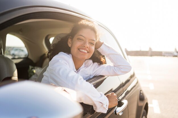 Happy woman posing out the window