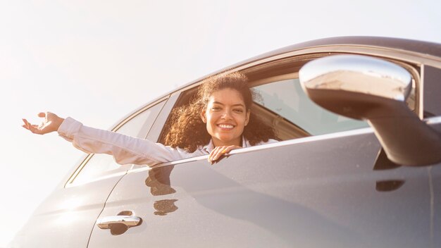 Happy woman posing out the window