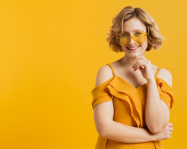 Happy woman posing while wearing sunglasses