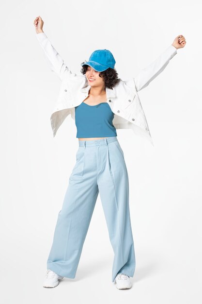 Happy woman posing in white jacket and blue outfit