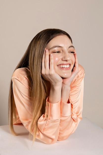 Free photo happy woman posing with table medium shot