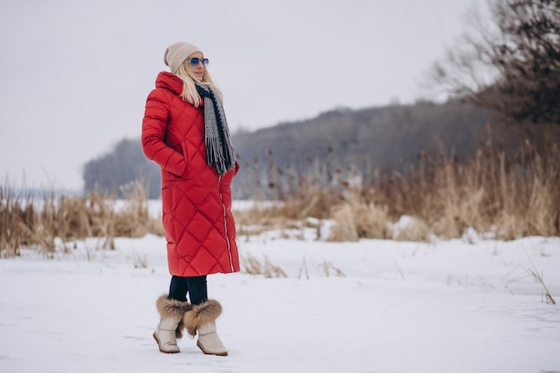 Happy woman in red jacket outside in winter