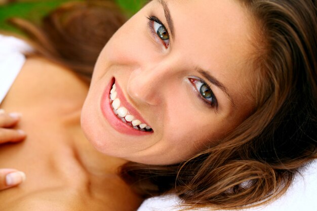 Happy woman relaxing on the deckchair