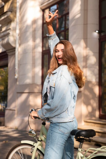 Happy woman riding her bike outdoors in the city