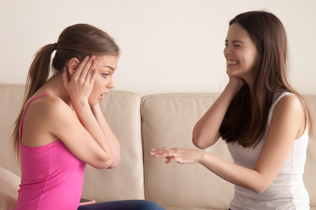 Free photo happy woman showing her engagement ring to friend