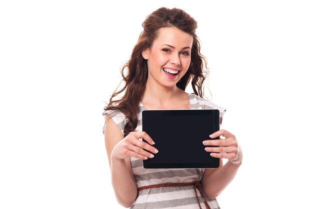 Happy woman showing screen of digital tablet