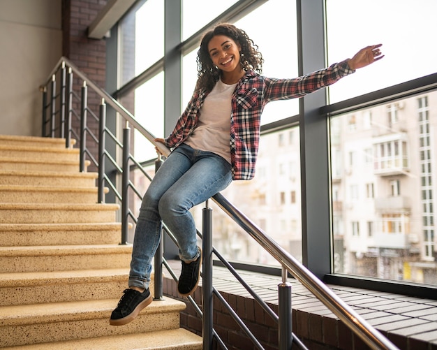 Happy woman sitting on the handrail