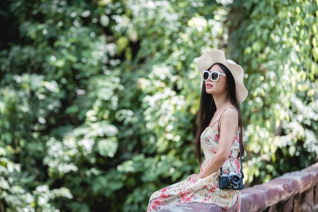 Happy woman sitting on railing in a park