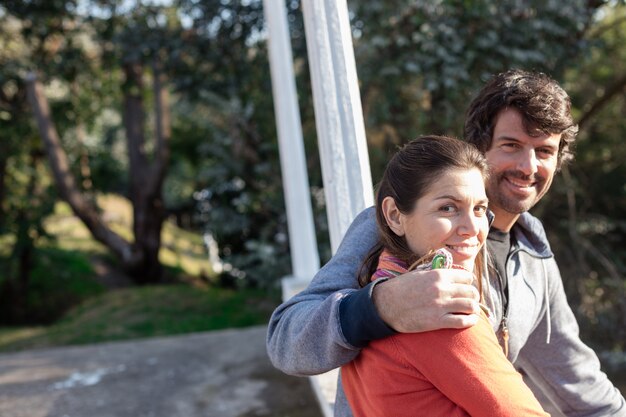 Happy woman sitting with her husband outdoors