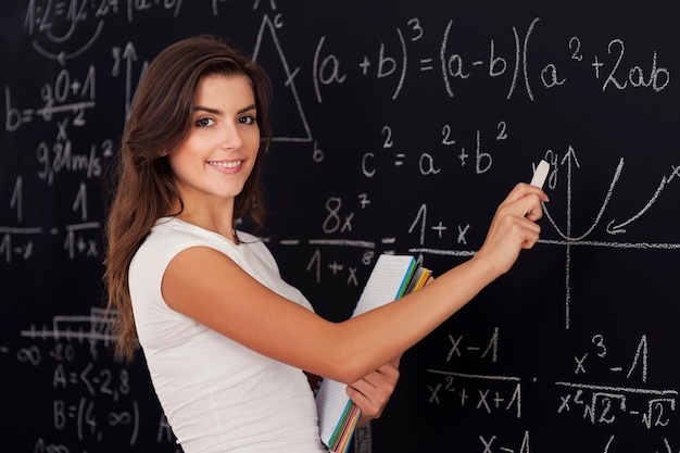 Happy woman solving mathematic problems