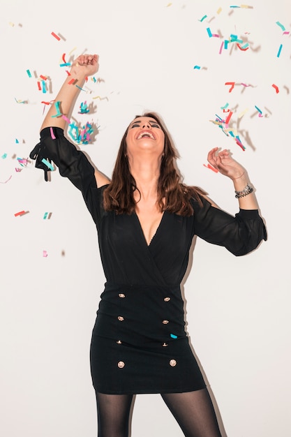 Happy woman standing under spangles 