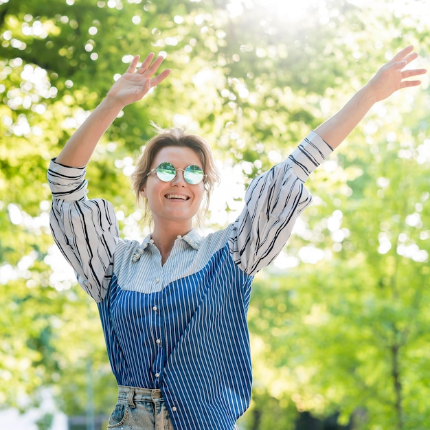 Free photo happy woman in summer park front view