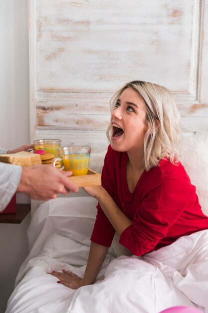 Happy woman surprised by boyfriend