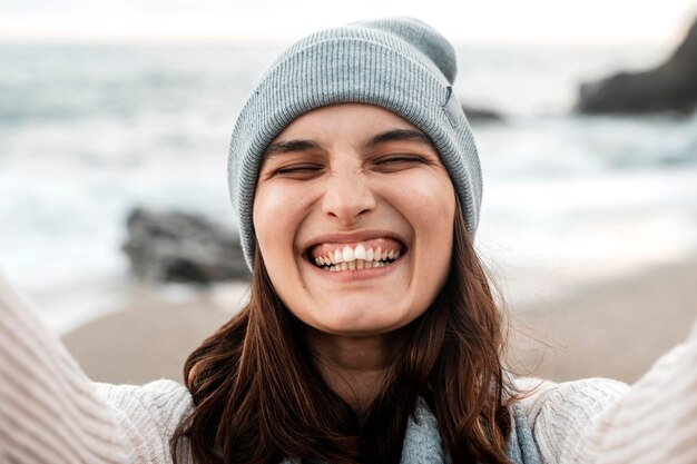 Happy woman taking a selfie at the beach