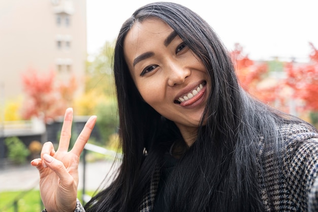 Happy woman taking selfie outside