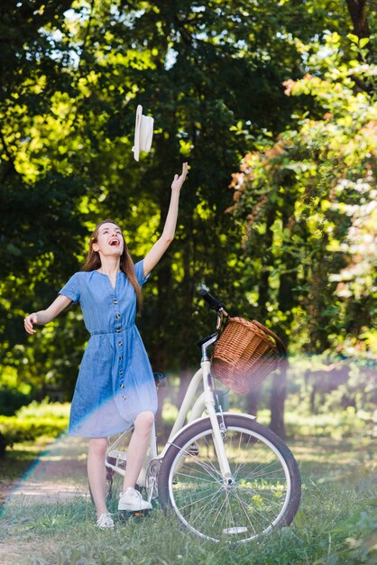 Happy woman throwing her hat in air