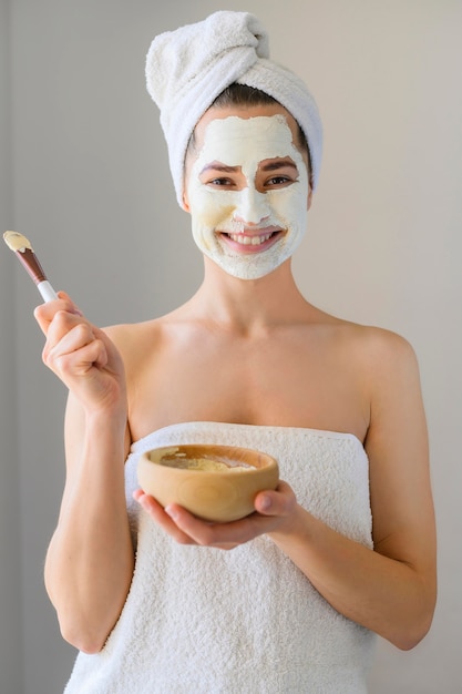 Happy woman wearing face mask and holding bowl