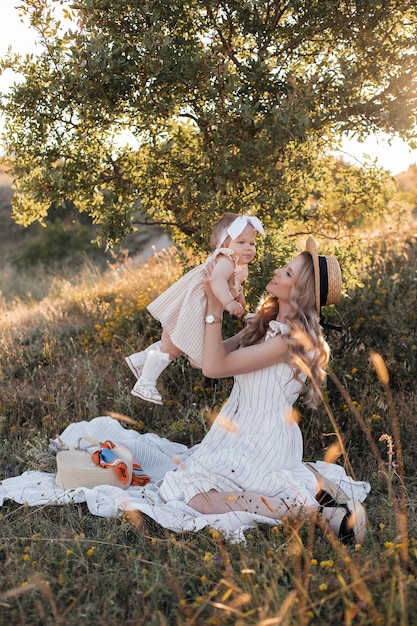 Free photo happy woman with baby child outdoors