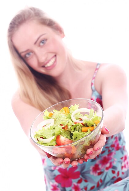 Happy woman with bowl of fresh salad