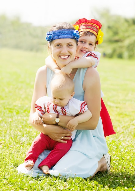 Free photo happy  woman with  children in  folk clothes