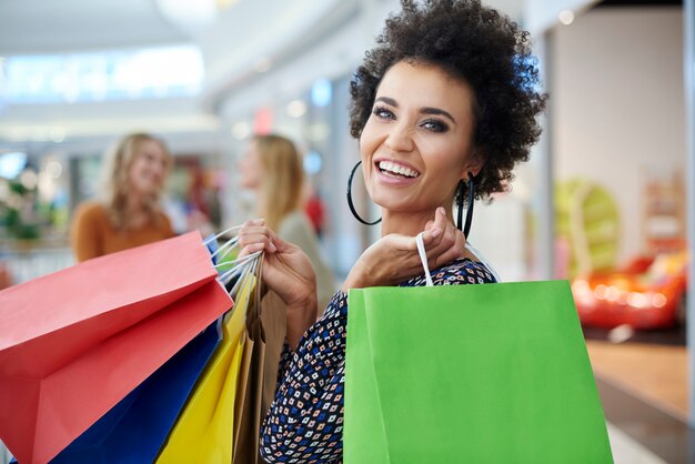 Happy woman with full shopping bags