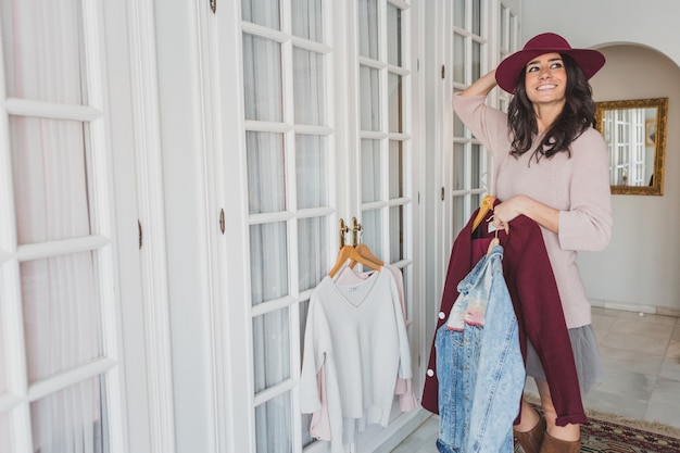 Happy woman with hat looking up