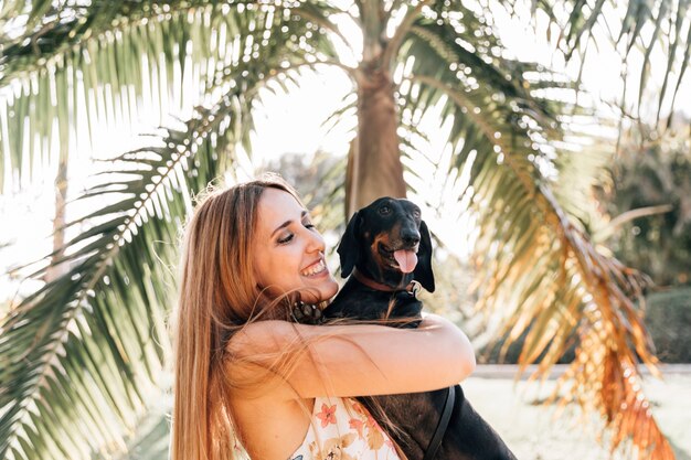 Happy woman with her dog sticking out tongue