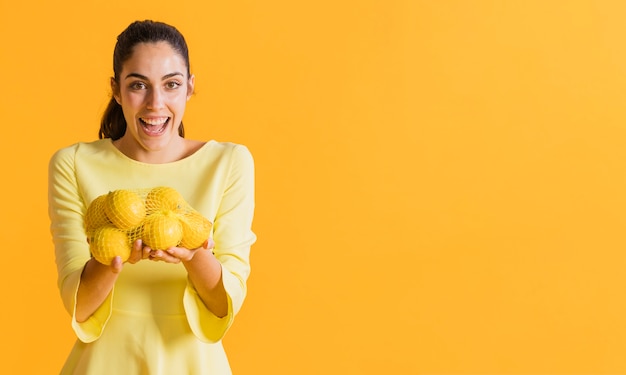 Free photo happy woman with lemons