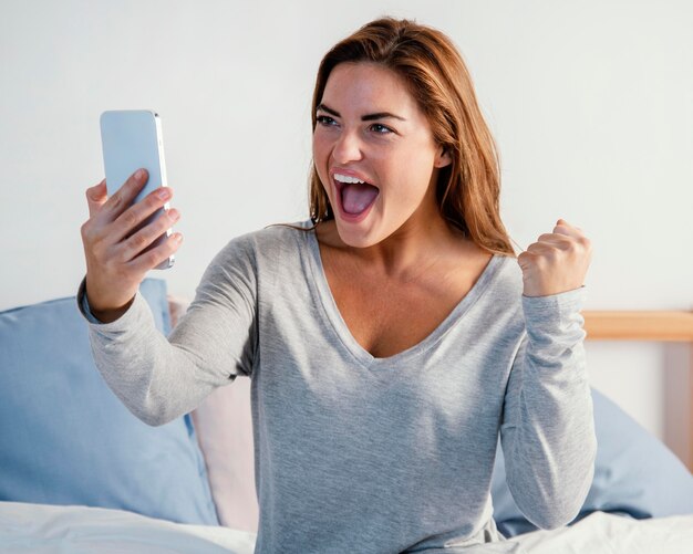 Happy woman with mobile in hand