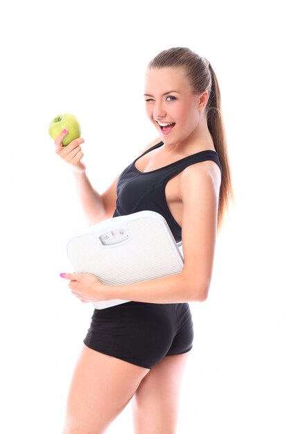 Happy woman with scales and green apple