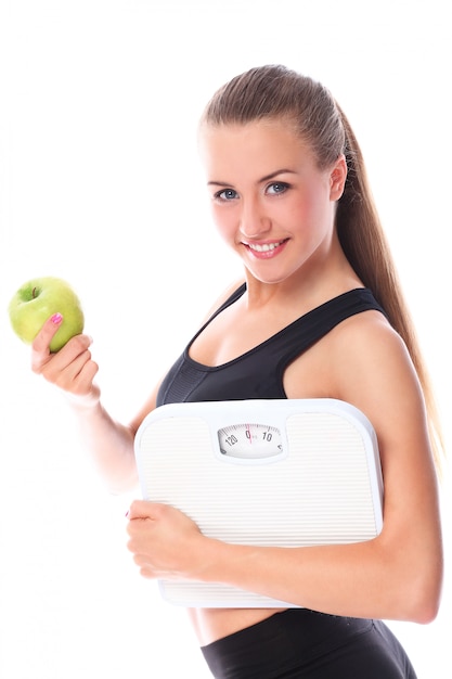 Happy woman with scales and green apple