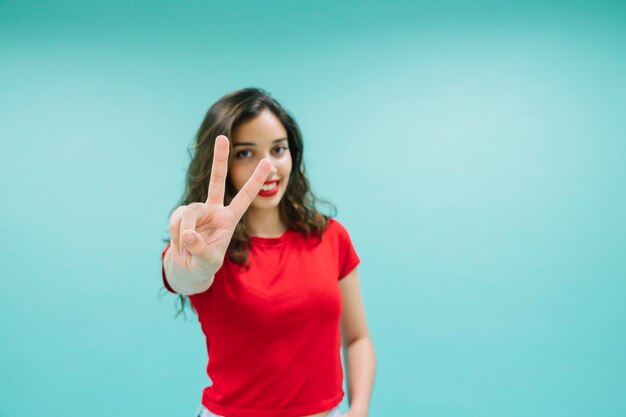 Happy woman with victory fingers