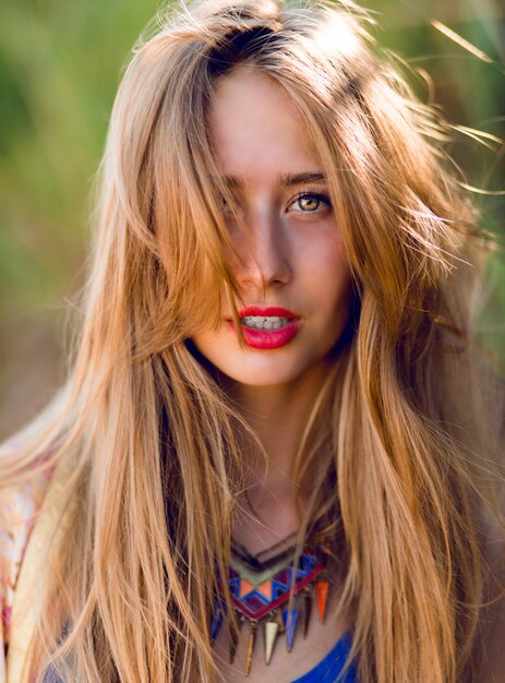 happy woman with windy blonde hair