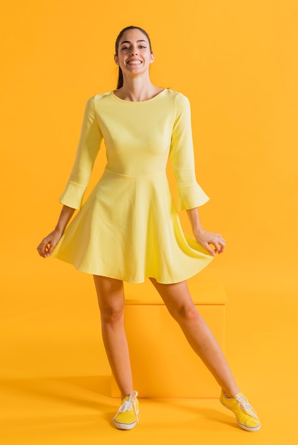 Free photo happy woman in a yellow dress