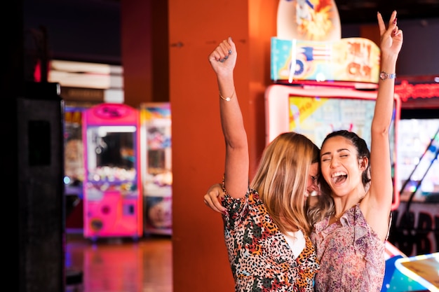 Happy women at an amusement arcade