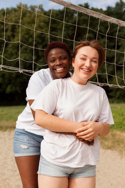 Happy women hugging each other outdoors