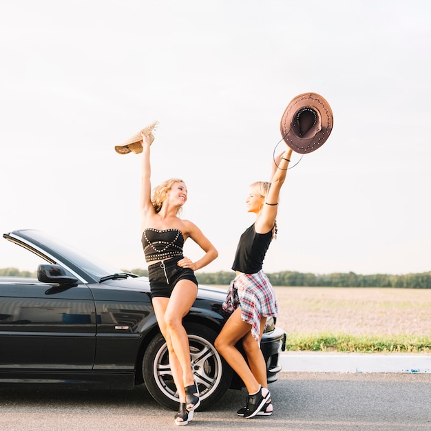 Happy women near car