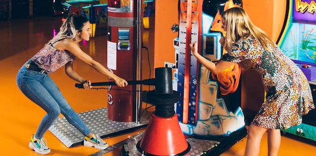 Happy women playing arcade game