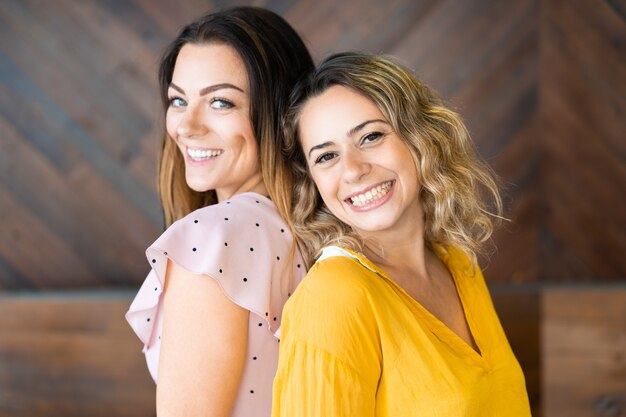 Happy women posing and looking at camera