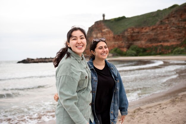 Happy women at seaside medium shot